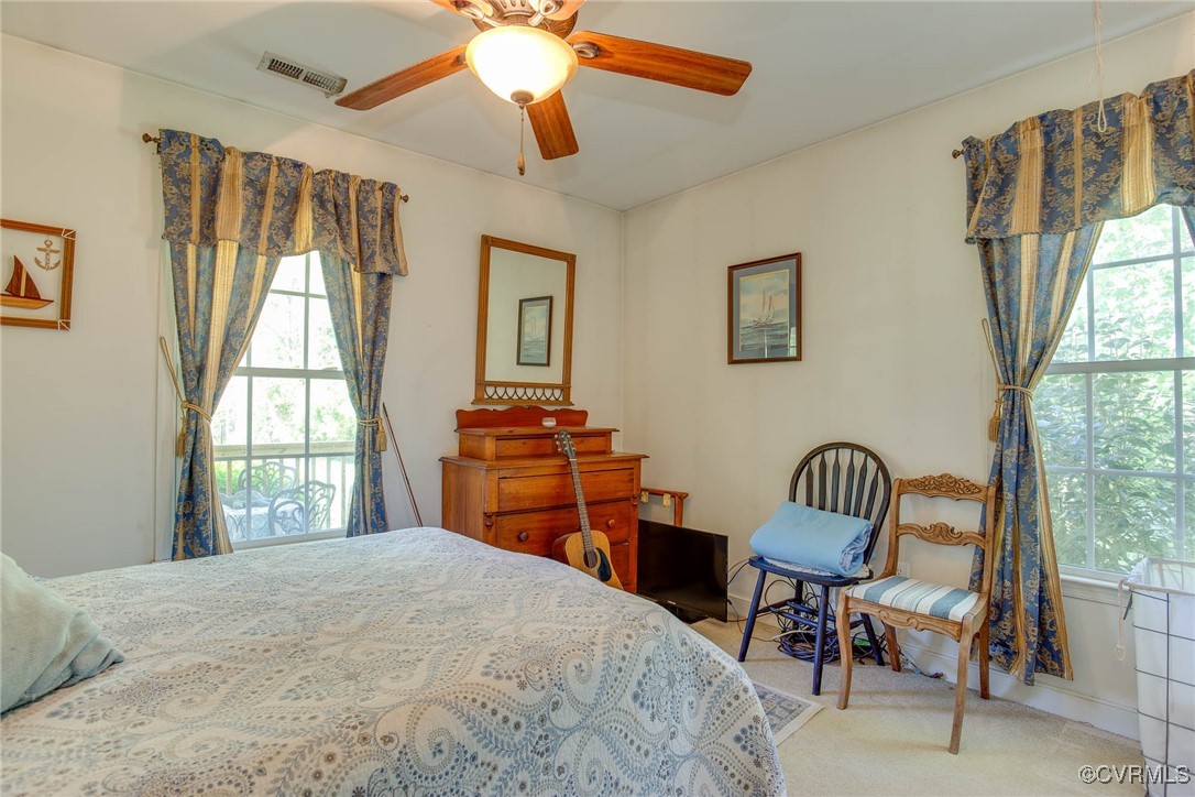 3875 Wakema Road West Point, VA 23181 - Photo 30 of 45 a bedroom with a bed and a chair with outer view