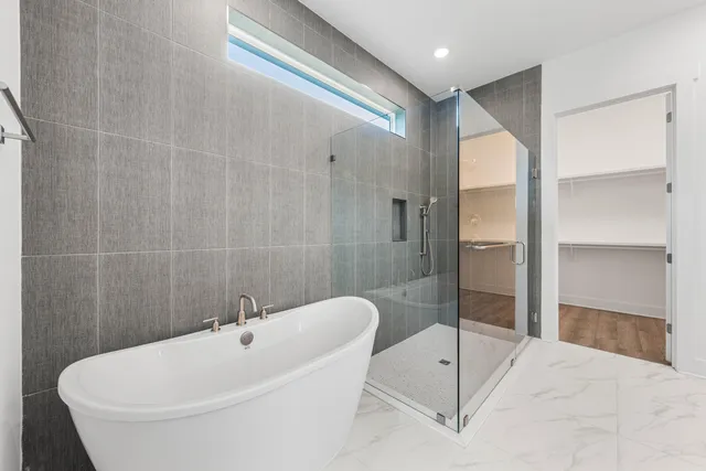 a bathroom with a tub and shower
