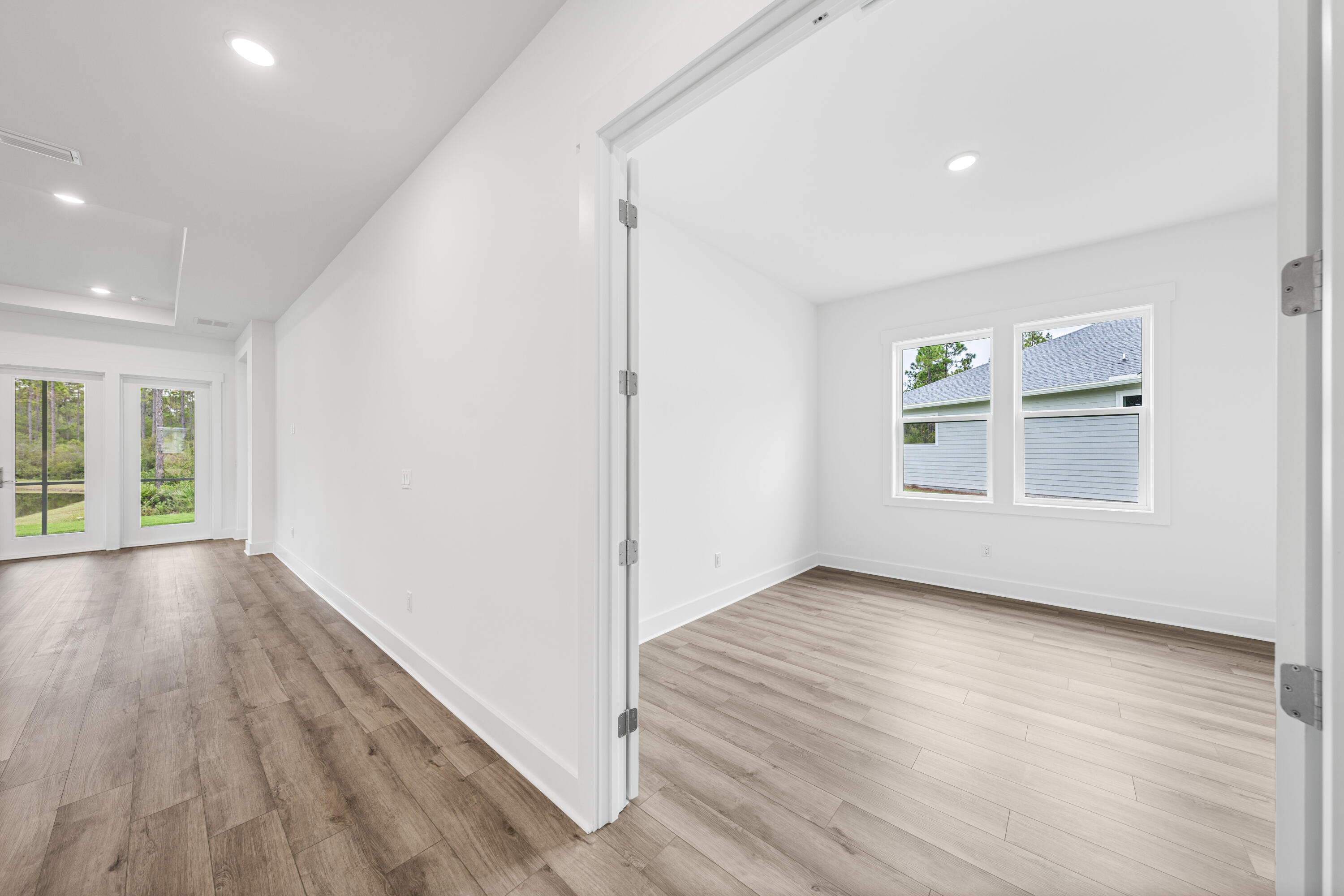 169 Orman Ct Inlet Beach Inlet Beach, FL 32461 - Photo 16 of 23 an empty room with wooden floor and windows