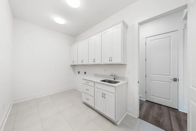 a kitchen with white cabinets and white appliances