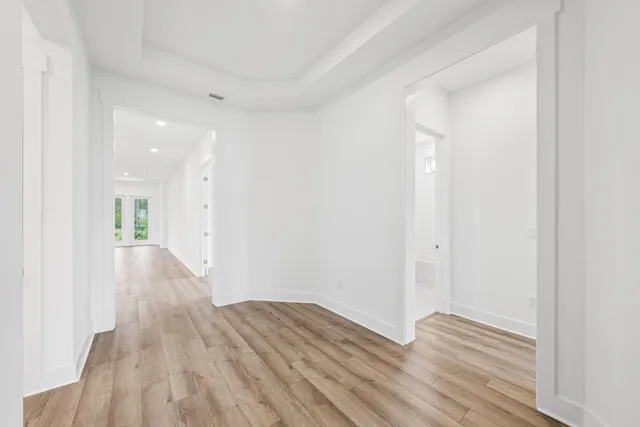 a view of a room with wooden floor