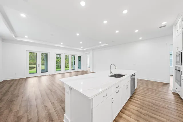 a very nice looking room with wooden floor and furniture