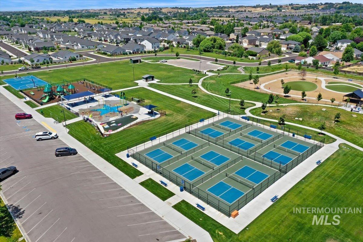 12310 West Hidden Point Drive Star, ID 83669 - Photo 44 of 48 Expansive recreational area featuring multiple pickleball courts, a basketball court, and a splash pad at Star’s Pavilion Park