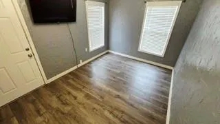 a view of front door with wooden floor