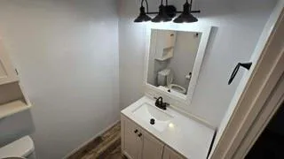 a bathroom with a sink and mirror