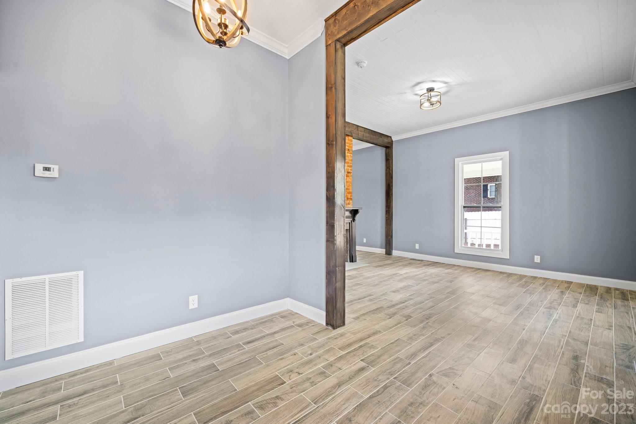 403 2nd Street Southeast Conover, NC 28613 - Photo 11 of 35 a view of an empty room with wooden floor and a window