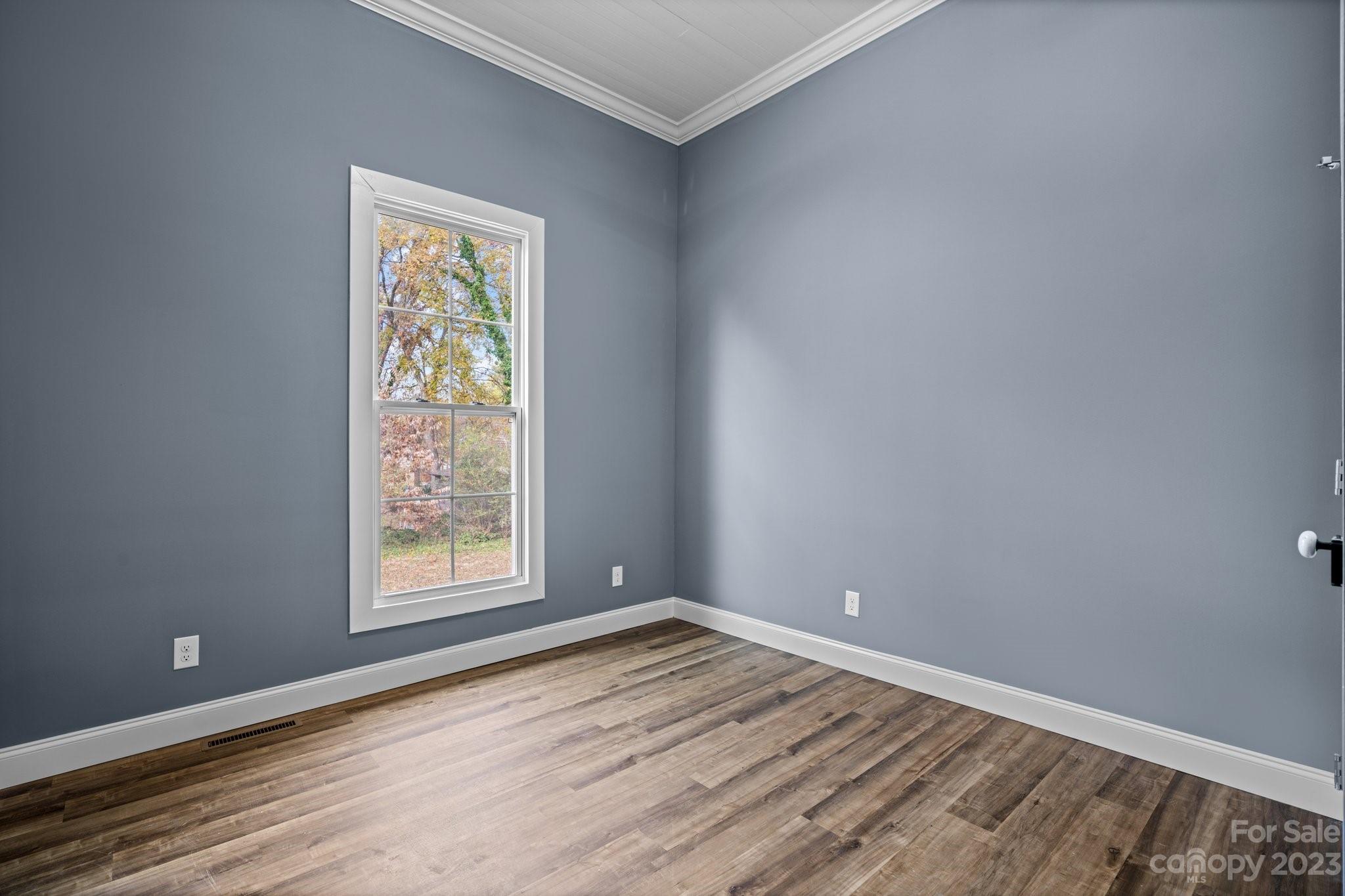 403 2nd Street Southeast Conover, NC 28613 - Photo 31 of 35 an empty room with wooden floor and a window