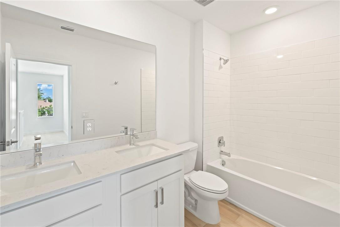 5653 Stradella Drive Boca Raton, FL 33433 - Photo 11 of 26 a bathroom with a sink a toilet and a bathtub