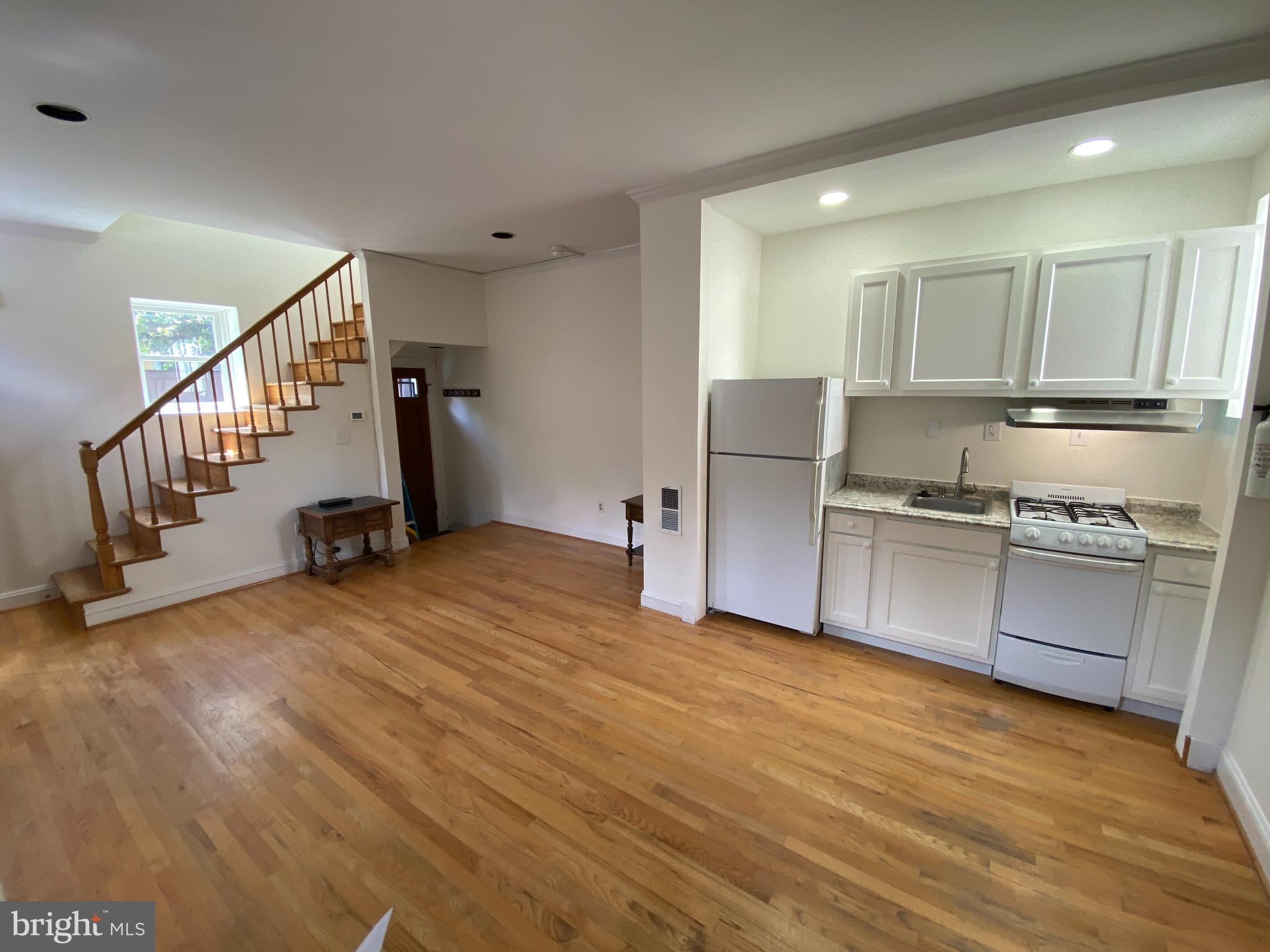 600 Acker Place Northeast Washington, DC 20002 - Photo 4 of 17 a open kitchen with stainless steel appliances granite countertop a refrigerator and a stove top oven