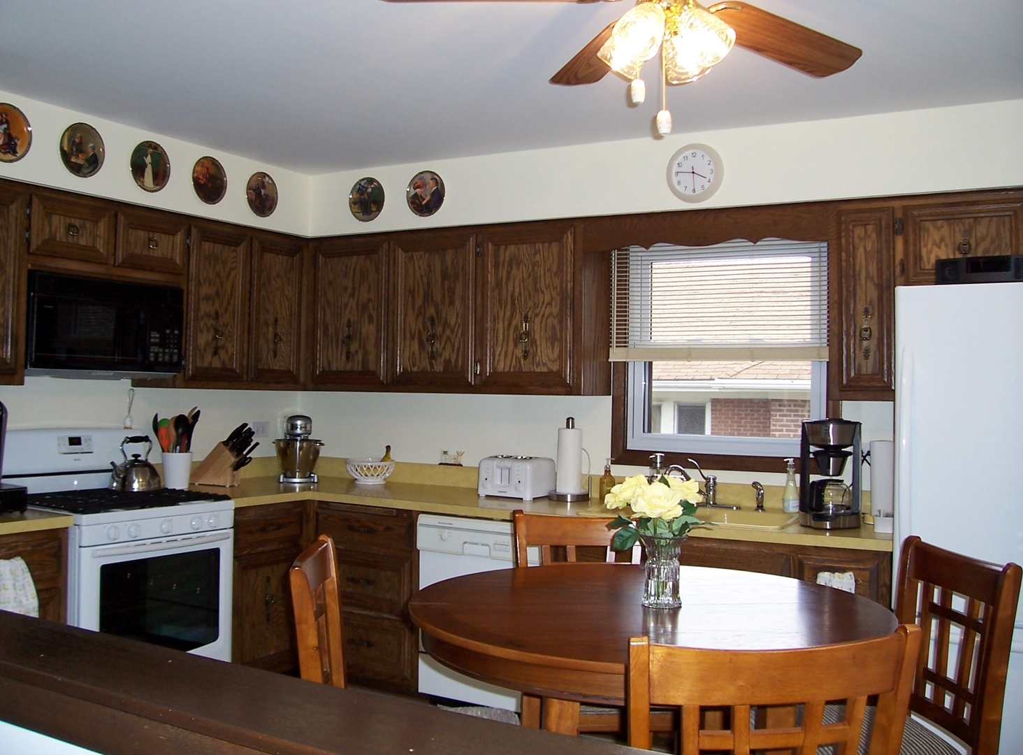 411 Lemont Street Lemont, IL 60439 - Photo 14 of 31 a kitchen with a dining table and chairs