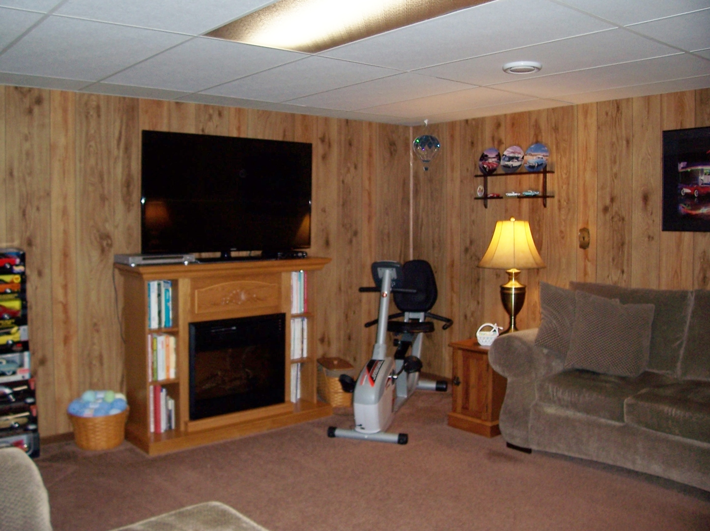 411 Lemont Street Lemont, IL 60439 - Photo 24 of 31 a living room with furniture a flat screen tv and a fireplace