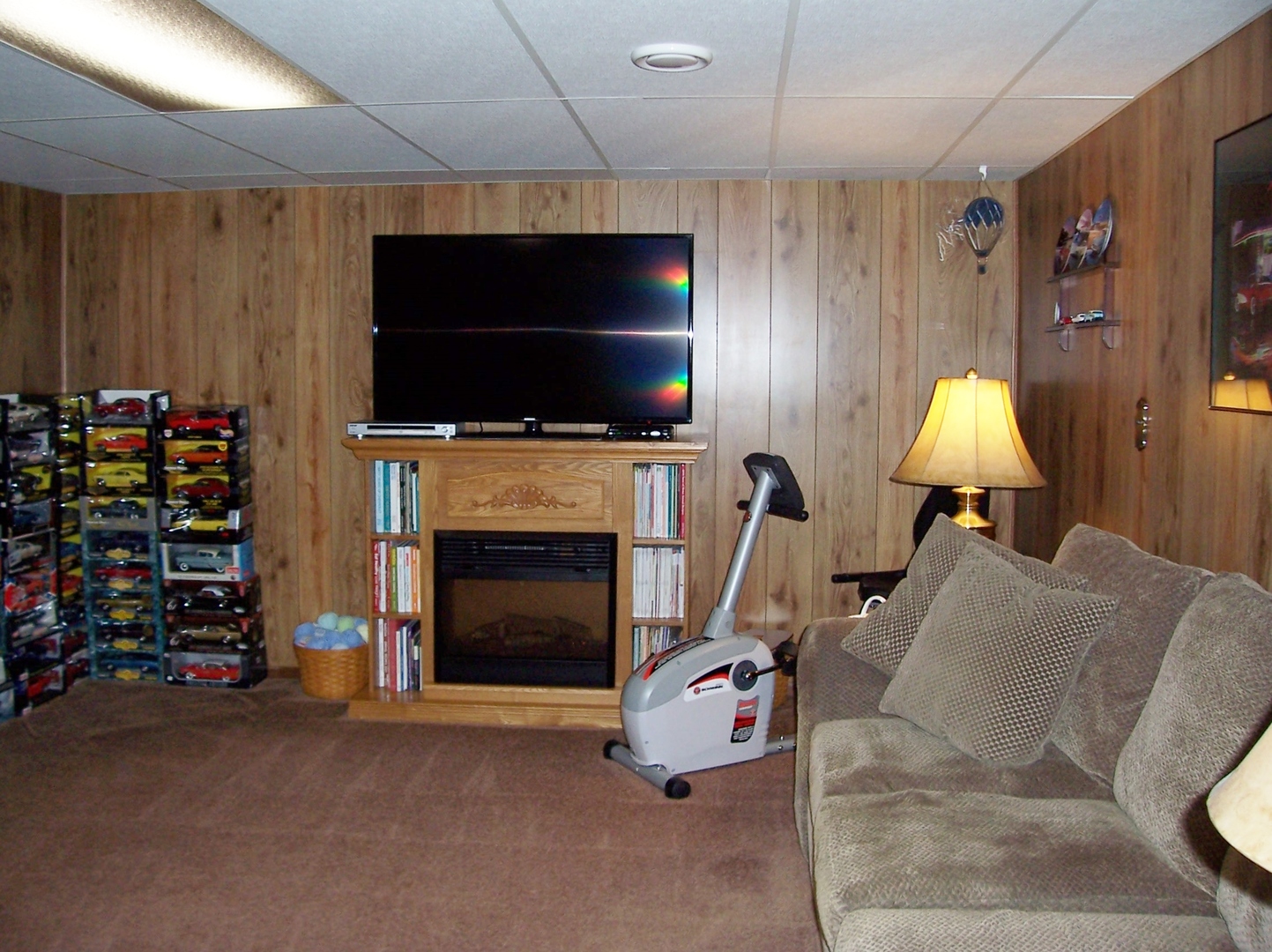 411 Lemont Street Lemont, IL 60439 - Photo 25 of 31 a living room with furniture a flat screen tv and a fireplace