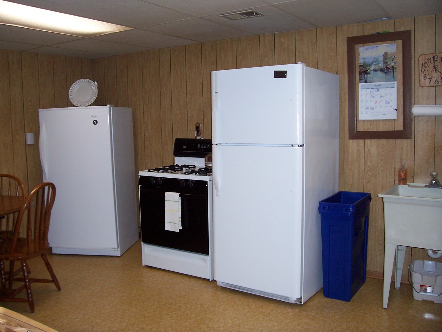 411 Lemont Street Lemont, IL 60439 - Photo 27 of 31 a white refrigerator freezer and a stove sitting inside of a kitchen