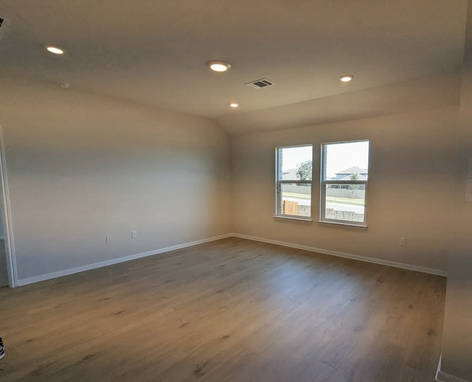 2412 Lightning View Leander, TX 78641 - Photo 8 of 24 Recessed lighting illuminates a versatile living space with light wood flooring and clear window views.