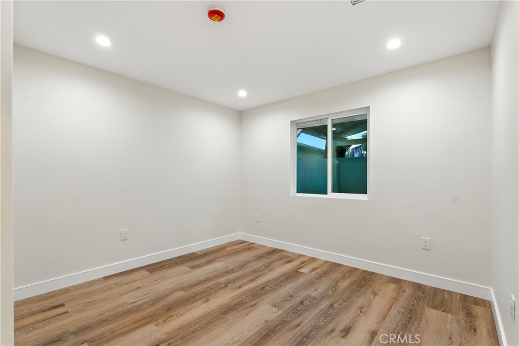4340 2nd Avenue Los Angeles, CA 90008 - Photo 41 of 54 an empty room with wooden floor and windows