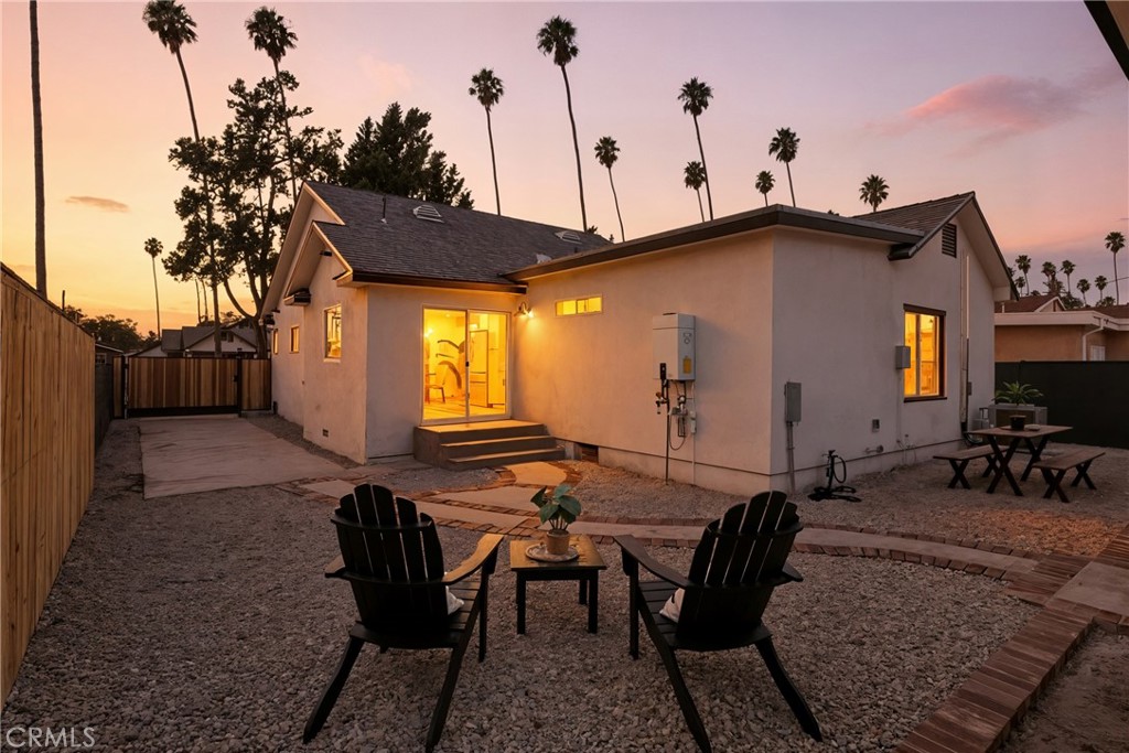 4340 2nd Avenue Los Angeles, CA 90008 - Photo 53 of 54 a view of a patio with table and chairs with wooden floor and fence