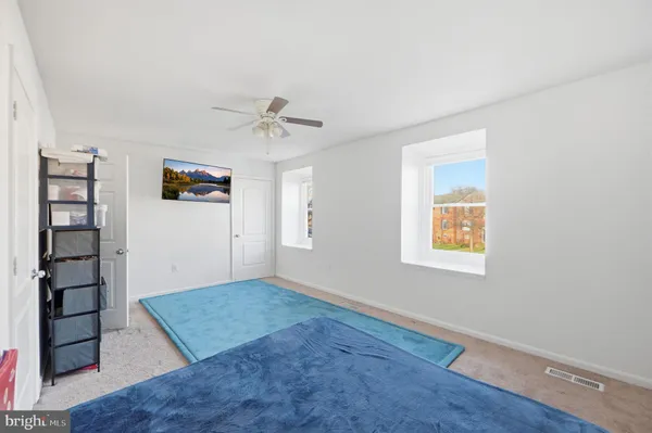 an empty room with windows and closet