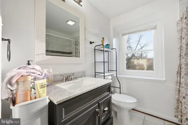 a bathroom with a sink a toilet and mirror