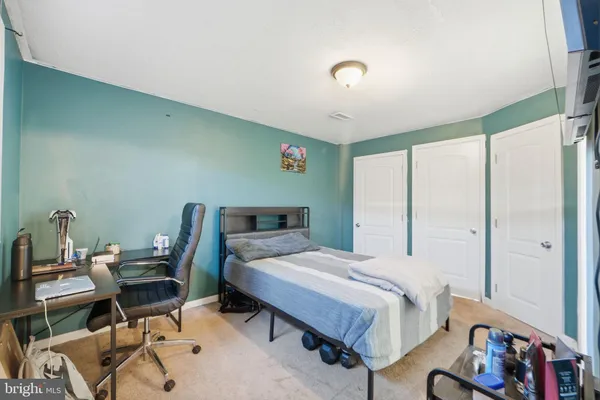 a bedroom with a bed and a desk