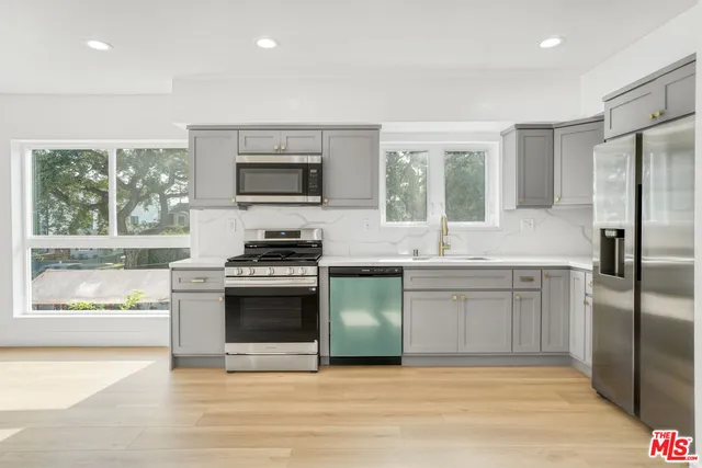 a kitchen with a stove a sink and a refrigerator