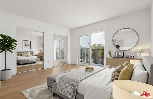 a bedroom with a large bed and a large window