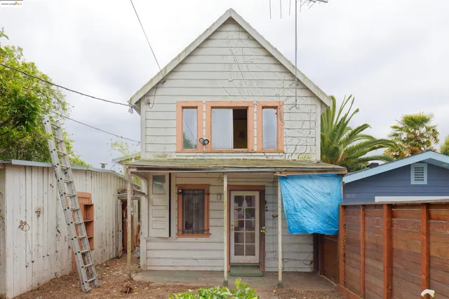 a view of a house with wooden fence