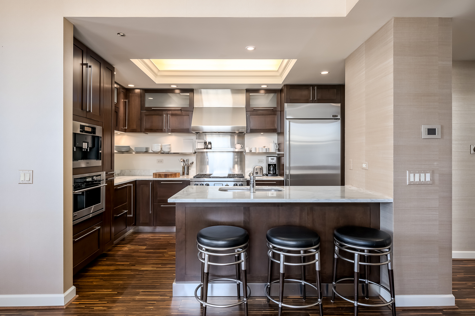 310 South Michigan Avenue, Unit 1900 Chicago, IL 60604 - Photo 11 of 29 a kitchen with kitchen island a stove and a refrigerator