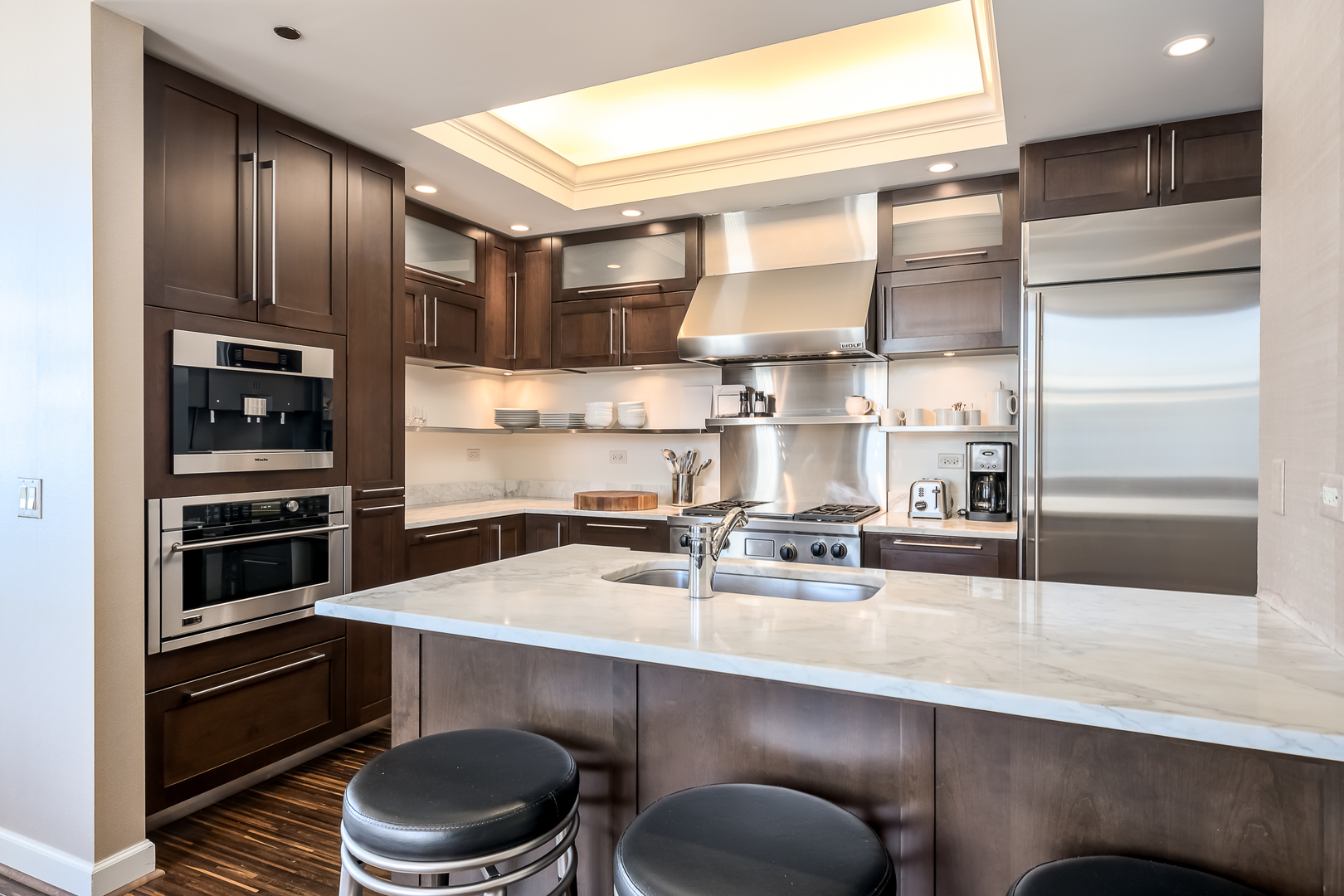 310 South Michigan Avenue, Unit 1900 Chicago, IL 60604 - Photo 12 of 29 a kitchen with a sink a stove and chairs