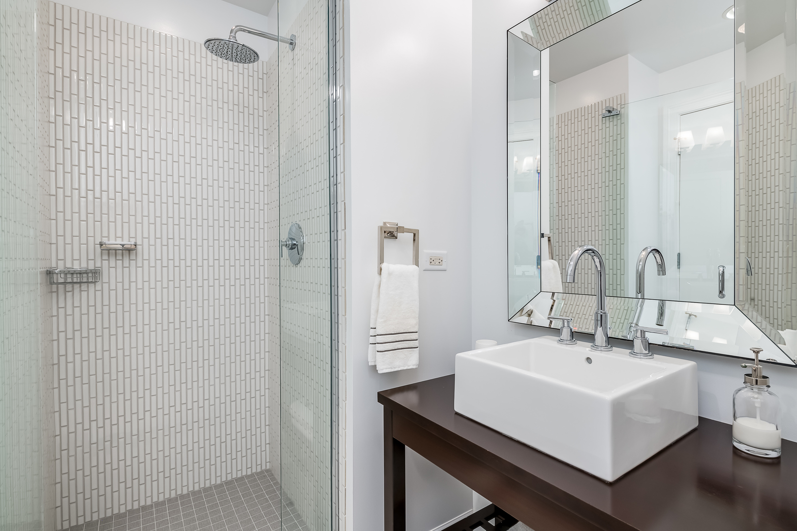 310 South Michigan Avenue, Unit 1900 Chicago, IL 60604 - Photo 24 of 29 a bathroom with a sink a mirror and a shower