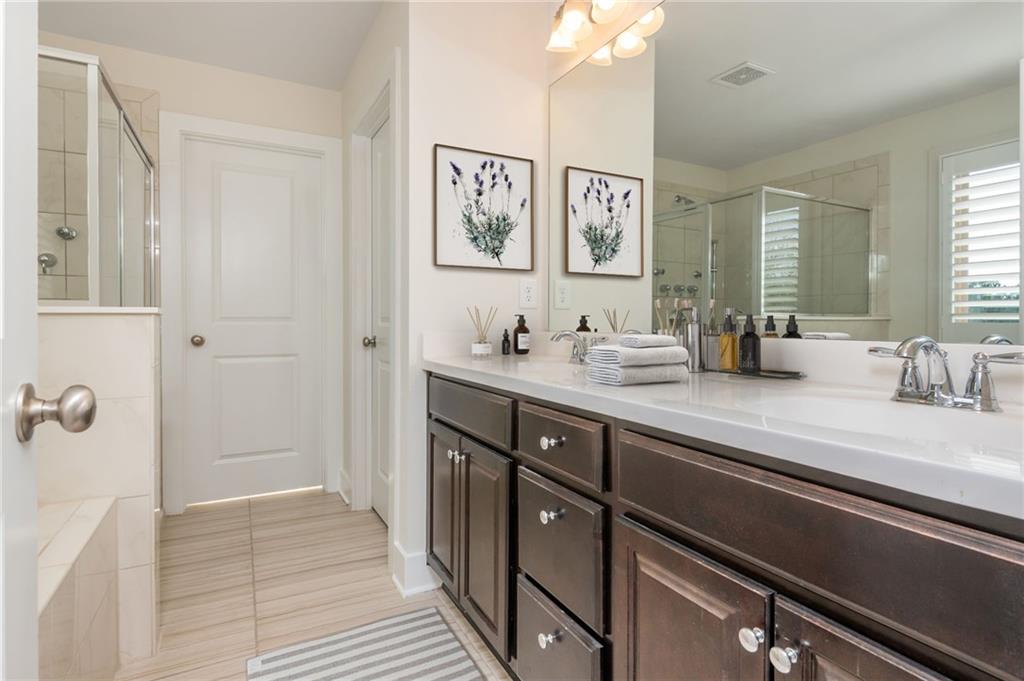 5914 High Hampton Lane Mableton, GA 30126 - Photo 22 of 32 a spacious bathroom with a double vanity sink a mirror and shower