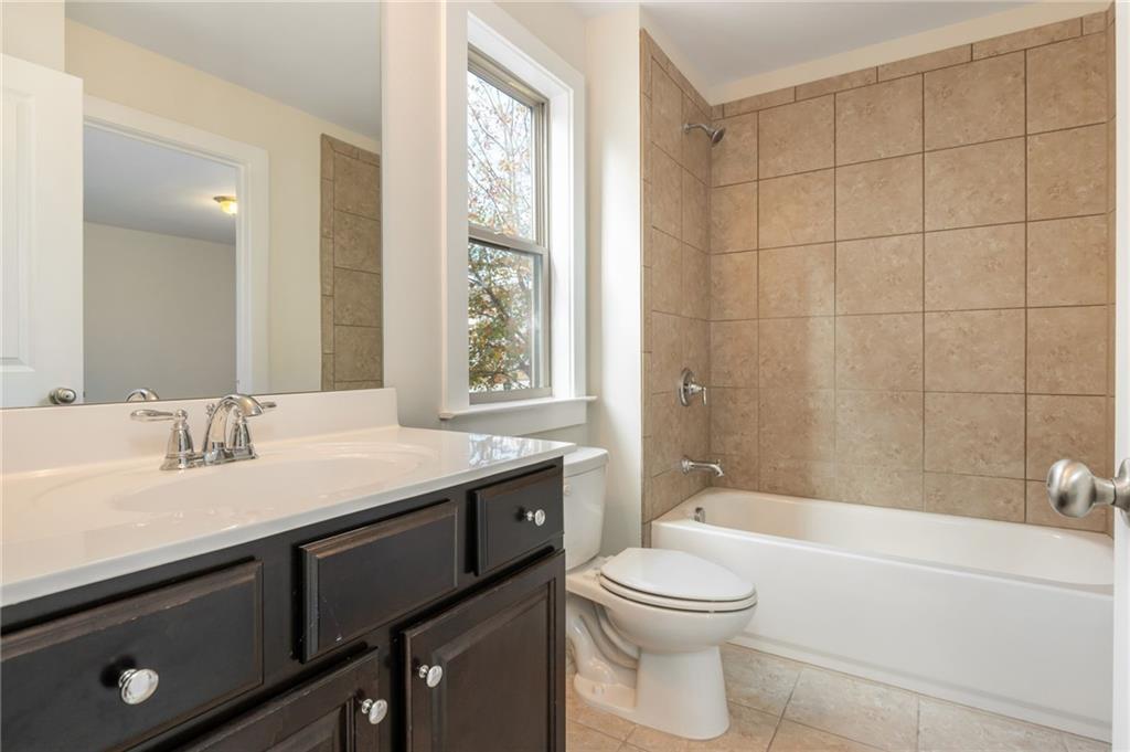 5914 High Hampton Lane Mableton, GA 30126 - Photo 26 of 32 a bathroom with a granite countertop sink a toilet and shower