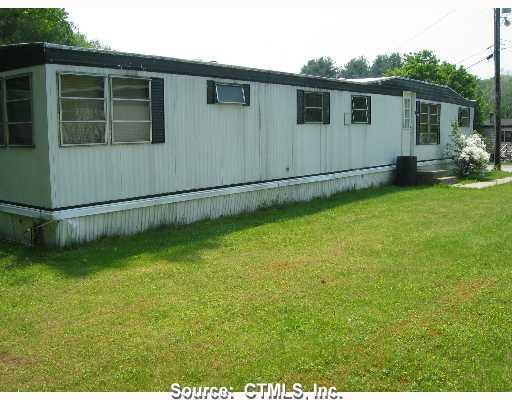 74 R&r Park Dayville, CT 06241 - Photo 1 of 1 a backyard of a house with wooden fence