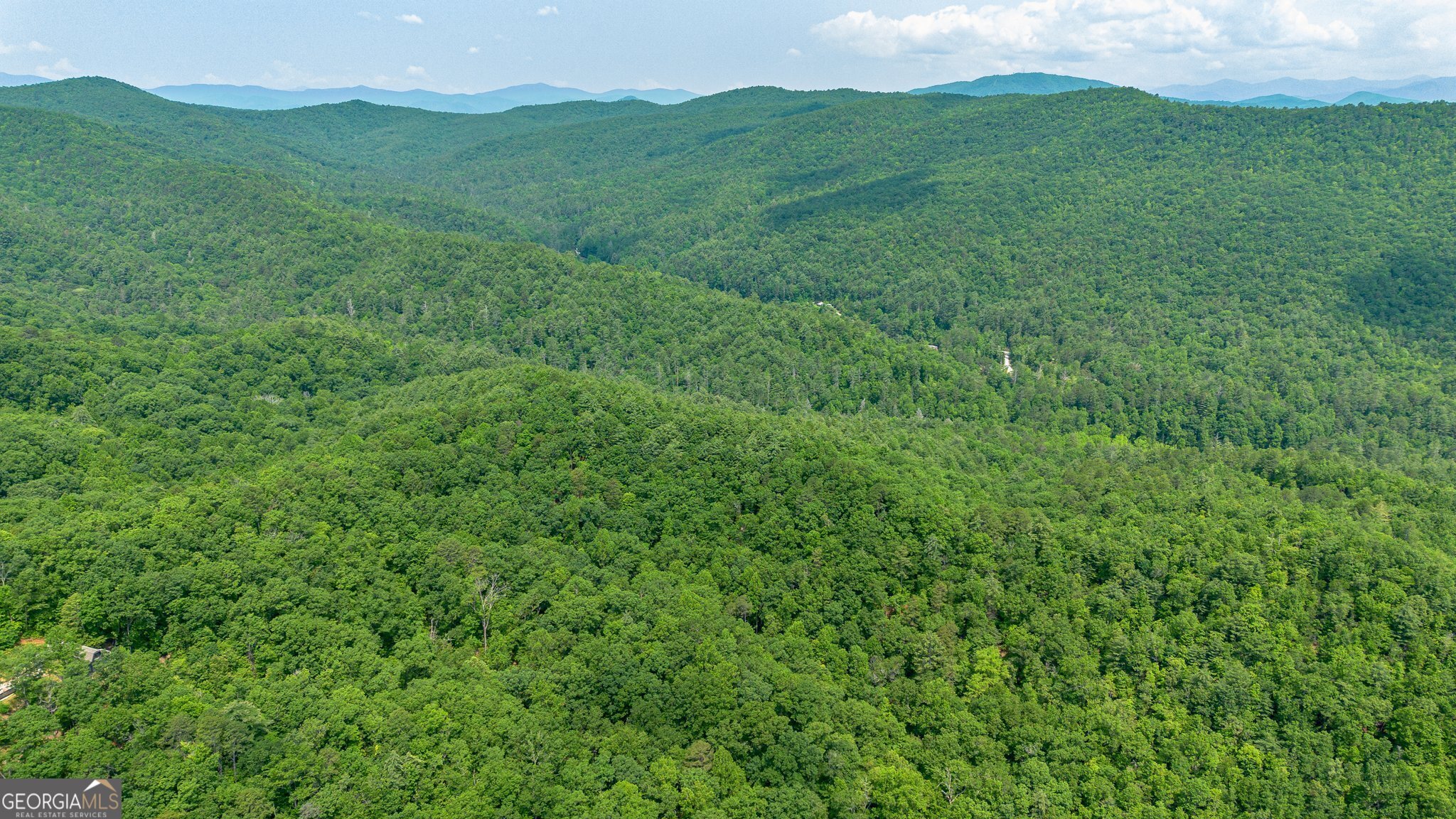 0 Grizzly Ridge Road Lakemont, GA 30552 - Photo 22 of 75 a view of a lush green hillside and a building