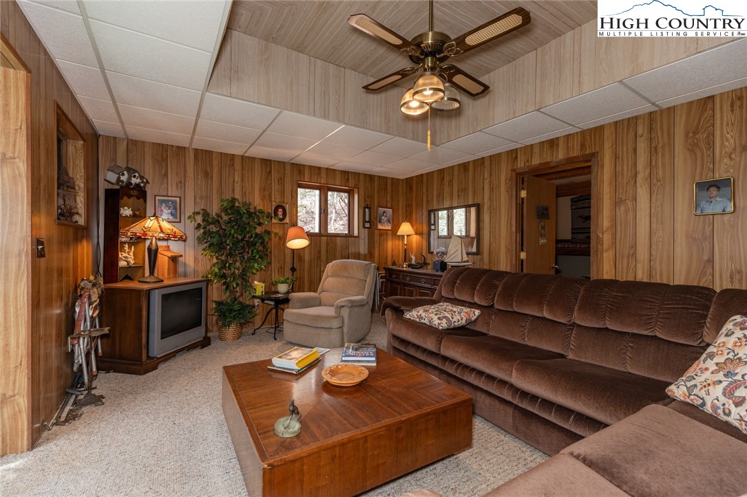 184 Birch Lane Deep Gap, NC 28618 - Photo 19 of 31 a living room with furniture a chandelier and a fireplace