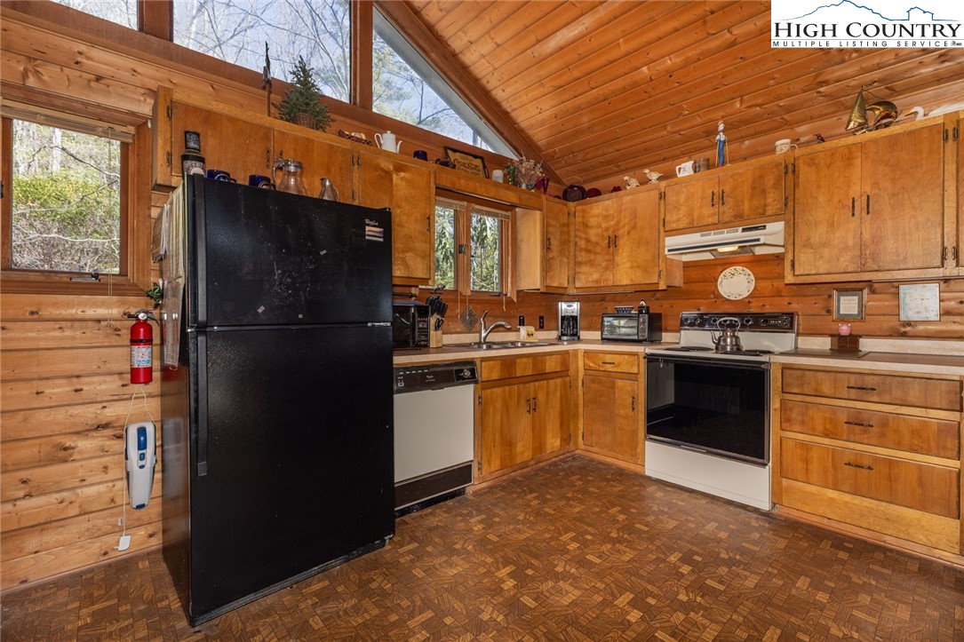 184 Birch Lane Deep Gap, NC 28618 - Photo 7 of 31 a kitchen with a refrigerator and white cabinets