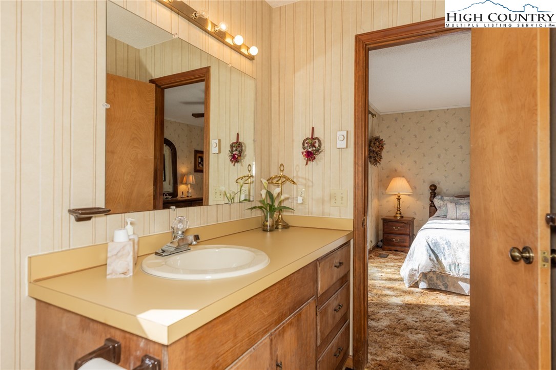184 Birch Lane Deep Gap, NC 28618 - Photo 10 of 31 a bathroom with a sink vanity granite and a mirror