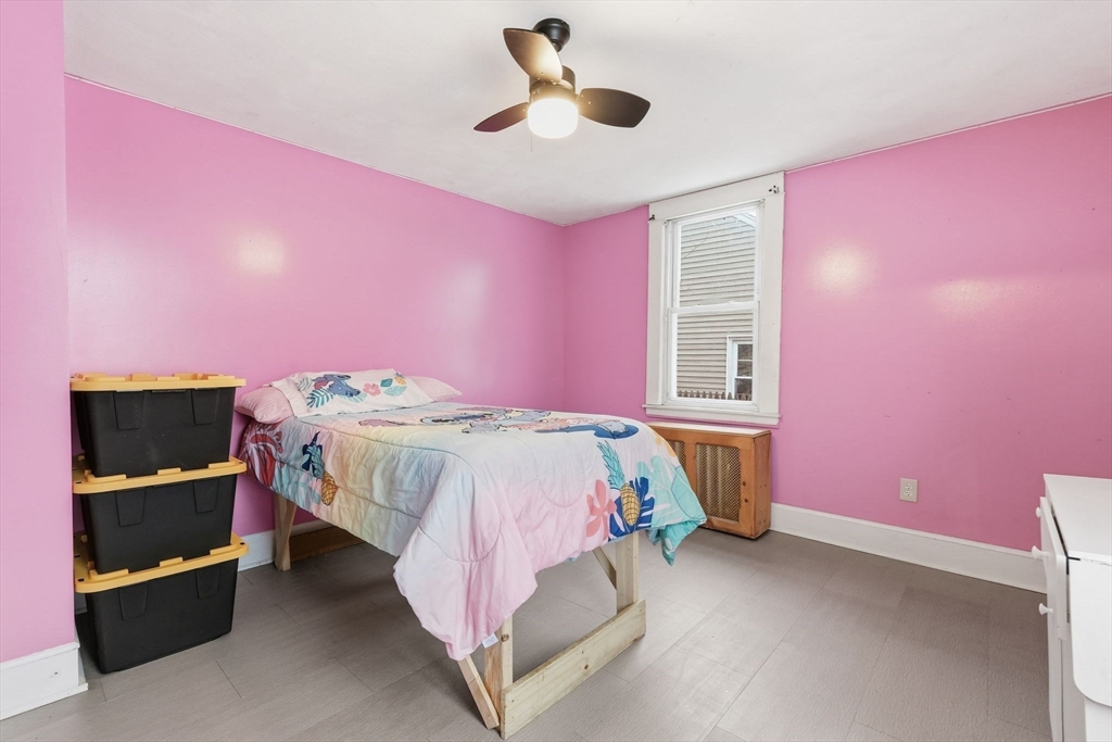 34 Savoy Avenue Springfield, MA 01104 - Photo 11 of 35 a bedroom with a bed and a ceiling fan