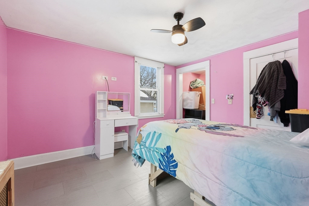 34 Savoy Avenue Springfield, MA 01104 - Photo 12 of 35 a bedroom with a bed and a chandelier