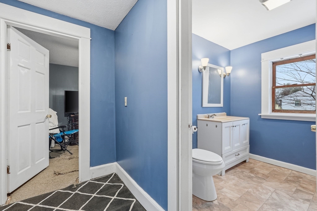 34 Savoy Avenue Springfield, MA 01104 - Photo 23 of 35 a bathroom with a toilet sink and mirror