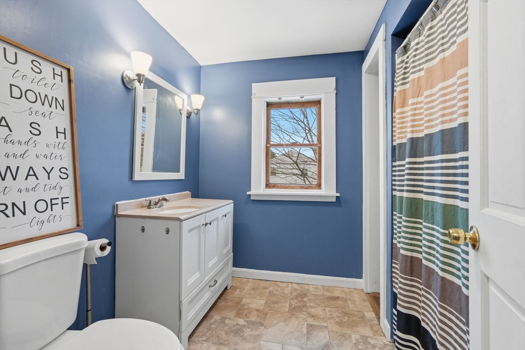 34 Savoy Avenue Springfield, MA 01104 - Photo 24 of 35 a bathroom with a toilet a sink and a mirror