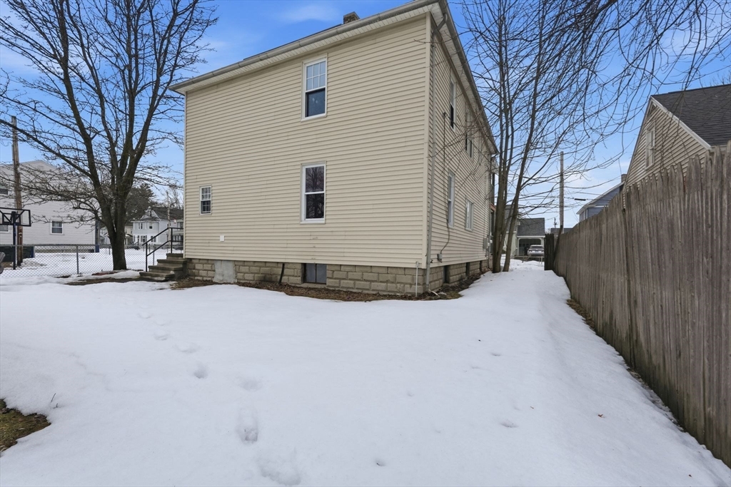 34 Savoy Avenue Springfield, MA 01104 - Photo 29 of 35 a view of a house with a yard covered in snow