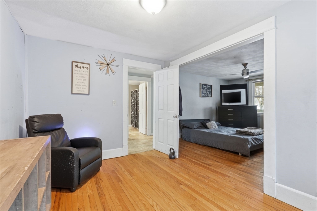 34 Savoy Avenue Springfield, MA 01104 - Photo 8 of 35 a bedroom with furniture and a wooden floor