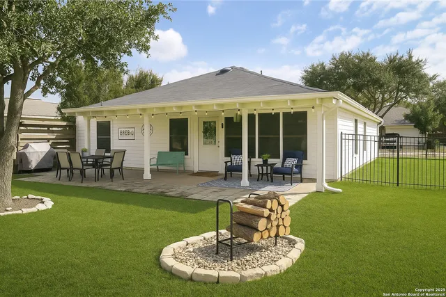 a view of a house with a yard patio and swimming pool