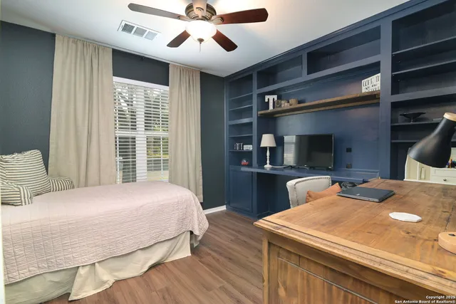 a bedroom with a large bed and a chandelier