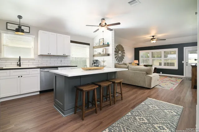 a kitchen with a sink stove and white cabinets