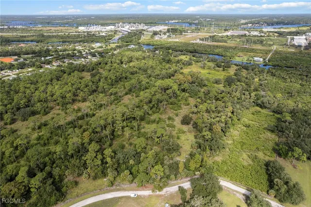 an aerial view of residential houses with outdoor space and river
