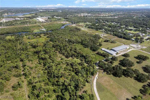 an aerial view of residential houses with outdoor space and lake view