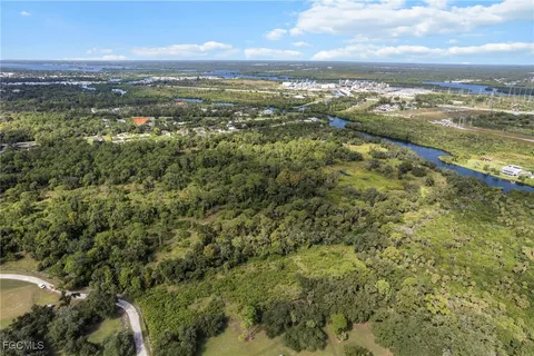 an aerial view of residential houses with outdoor space and ocean view