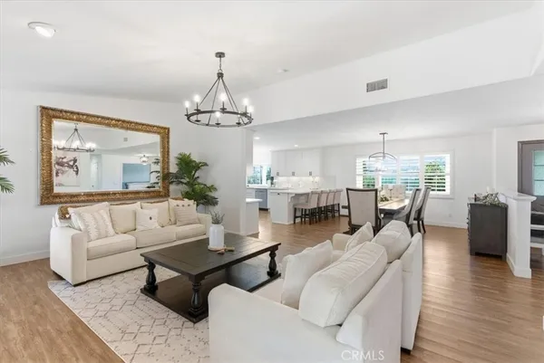 a living room with furniture and a chandelier