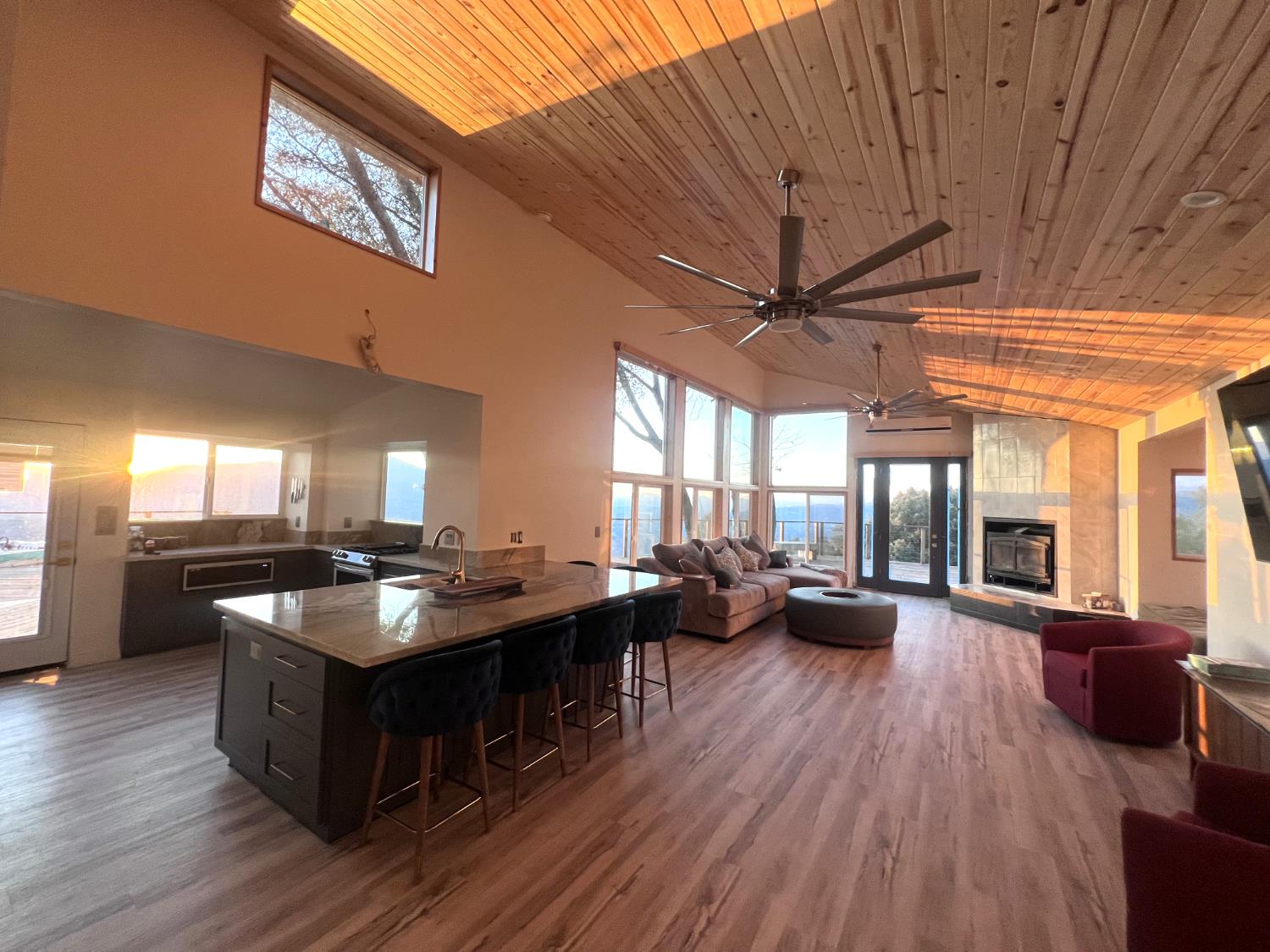 a kitchen with granite countertop lots of counter top space a sink a window and stainless steel appliances
